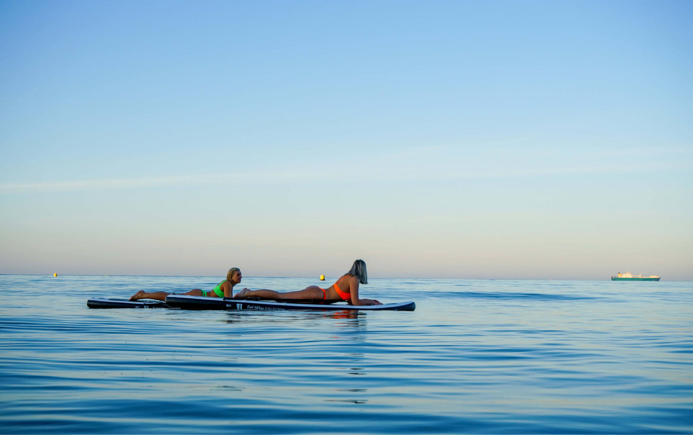 Beachbum® UK - women floating on Beachbum® paddle board on sunset