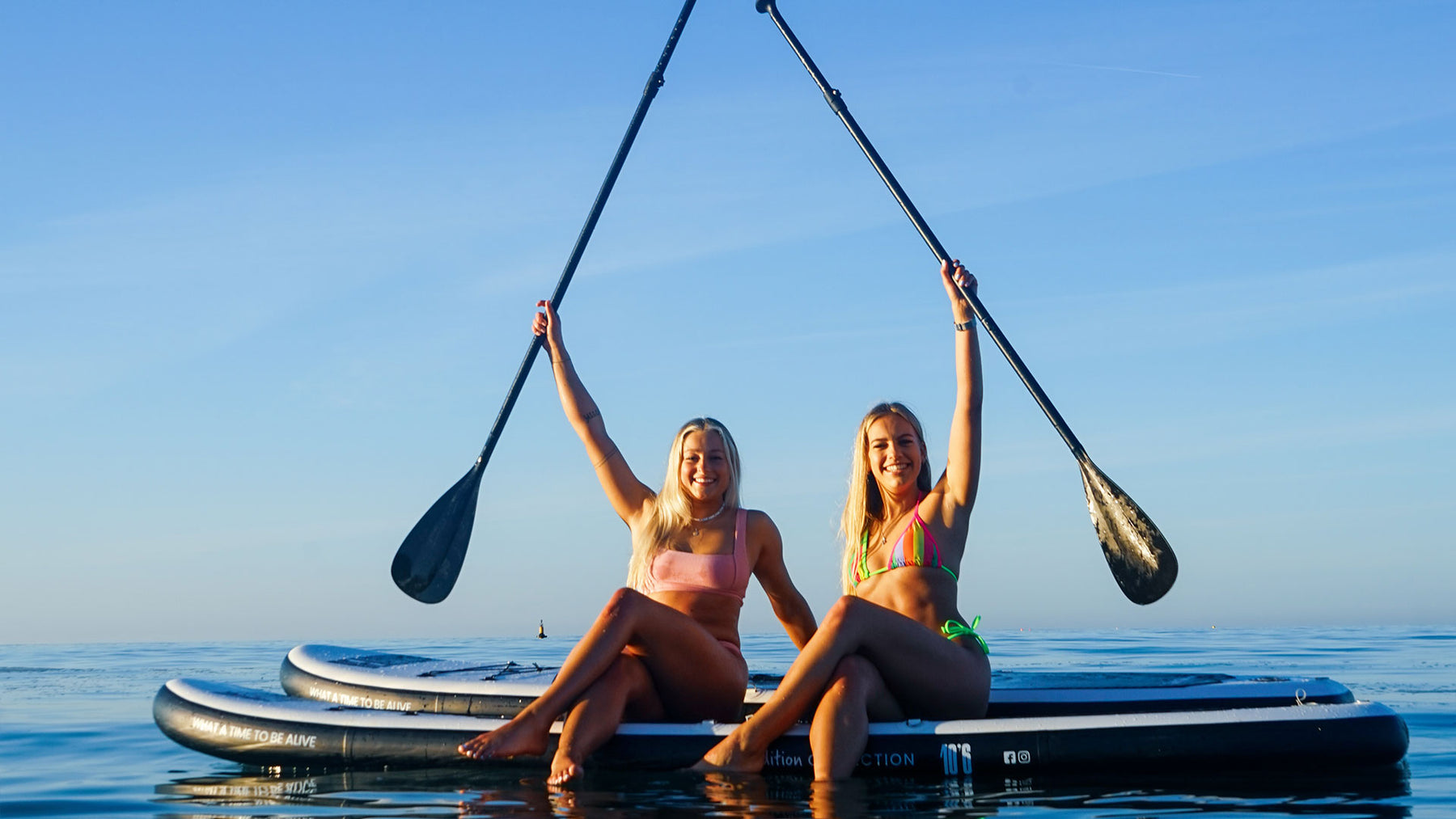 Beginners paddle boarding on inflatable Beachbum® The First Edition paddle boards